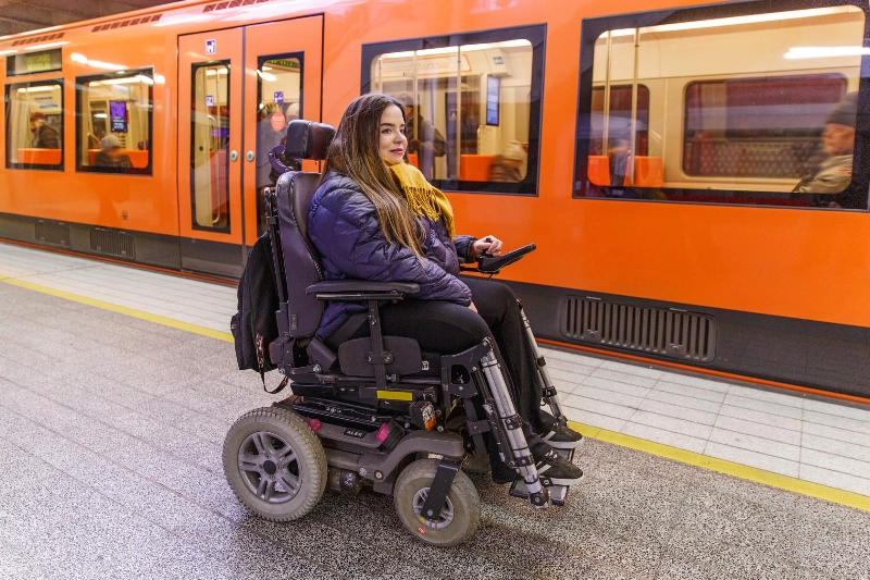 Woman waits for a metro sitting in a electric wheelchair. - Maija Astikainen / Helsinki Partners