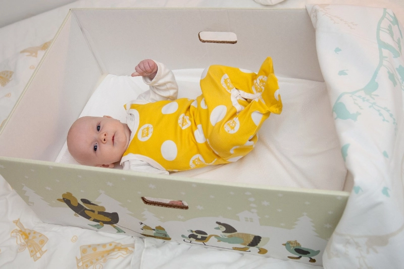 A baby inside a Finnish "baby box." - Annika Söderblom & Nana Uitto / Kela