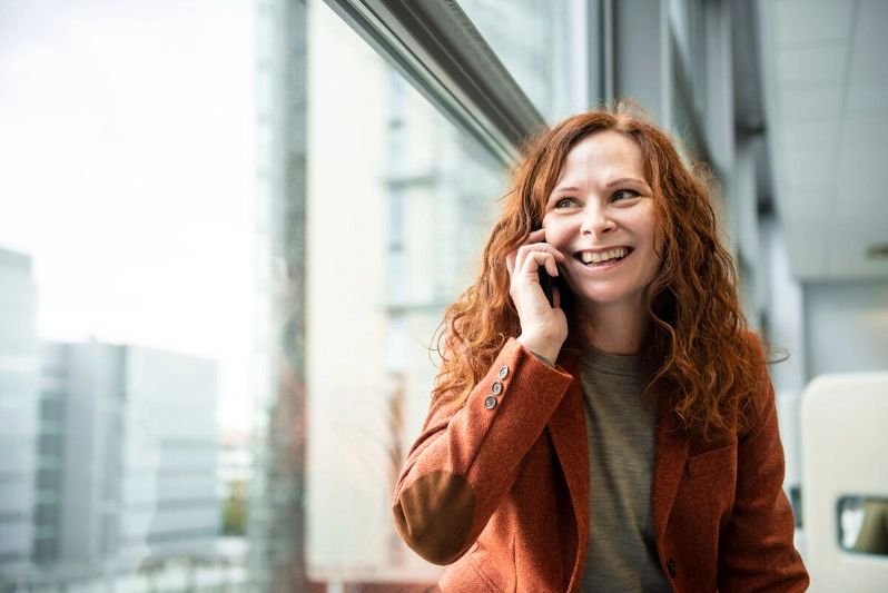 A smiling woman talks on her smartphone. - Markus Sommers / Business Finland