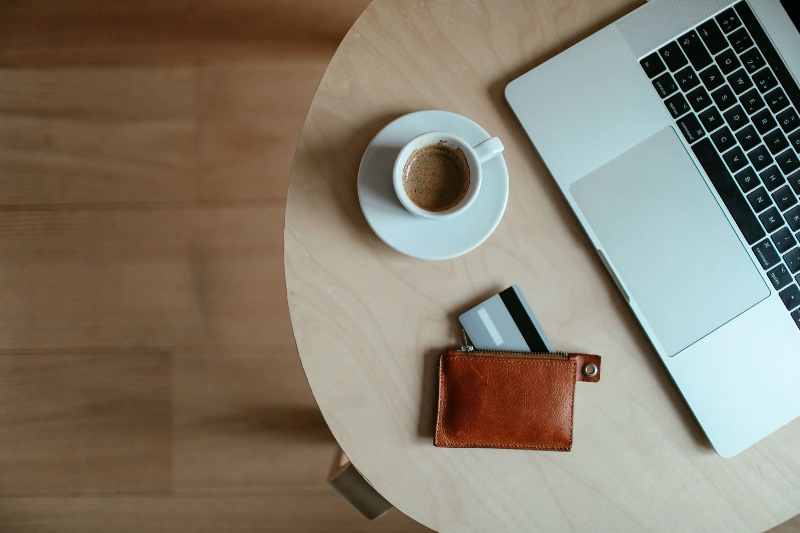 An open leather wallet on the ground. - Cup of Couple / Pexels