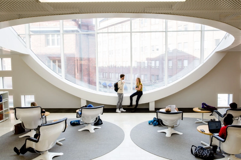 People work and study inside a university building.  - Team Finland